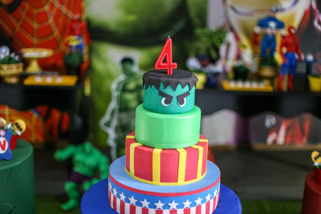 Vibrant superhero-themed birthday cake with a number four candle, perfect for kids' celebrations.